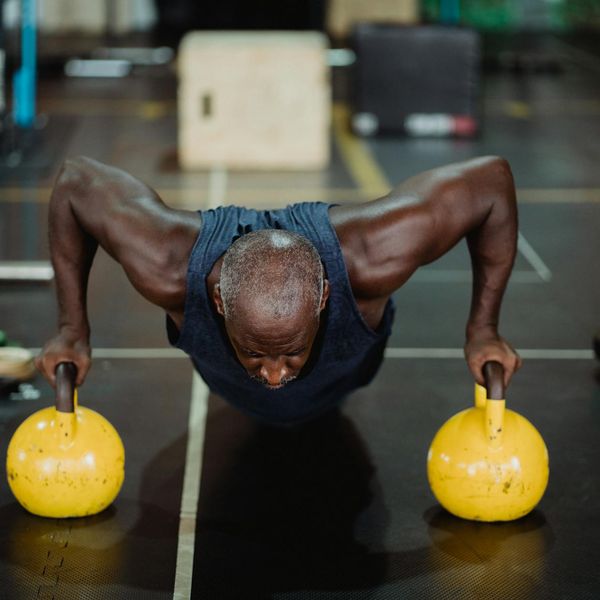 Athlete holding a kettlebell with a focused expression and perfect form.